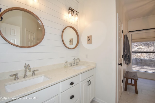 bathroom with tile patterned floors, crown molding, and vanity