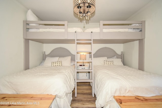 bedroom with hardwood / wood-style flooring and crown molding