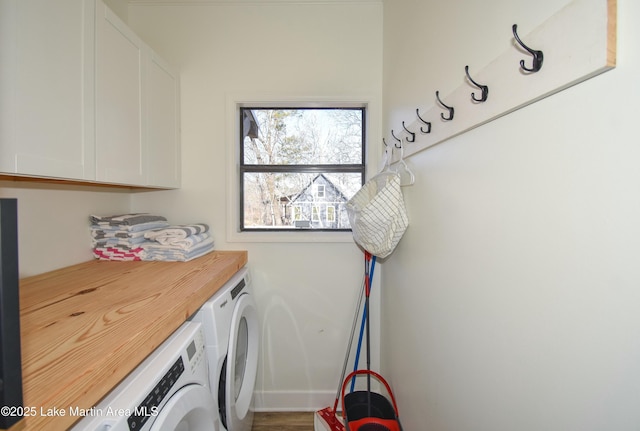 washroom with cabinets and washer and dryer