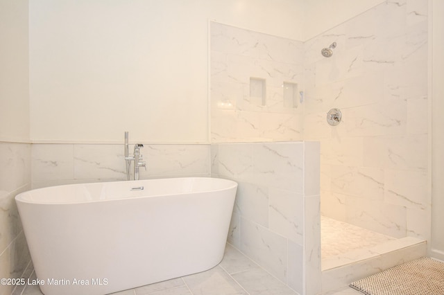 bathroom with tile walls and independent shower and bath