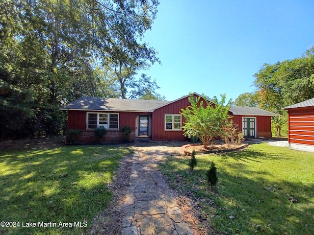 single story home with an outbuilding and a front yard