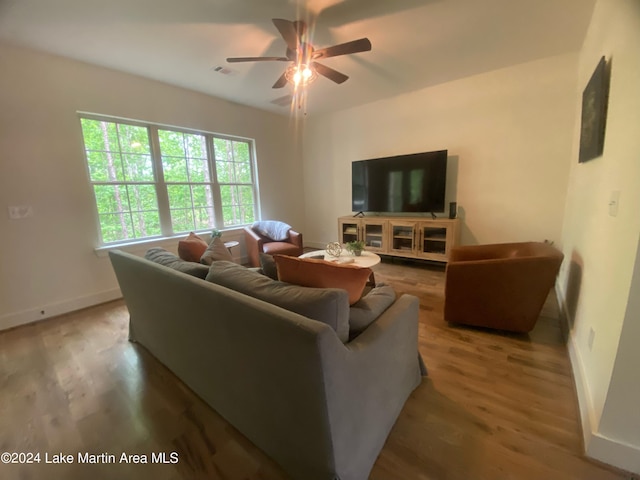 living room featuring ceiling fan and hardwood / wood-style floors