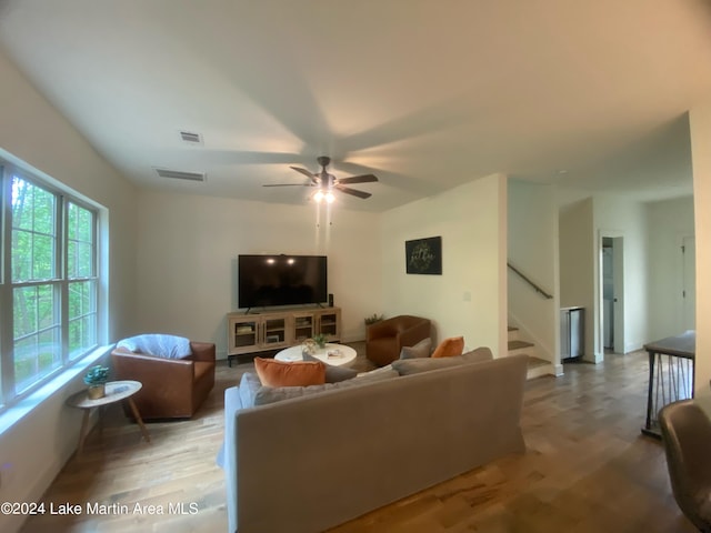 living room featuring ceiling fan and hardwood / wood-style flooring