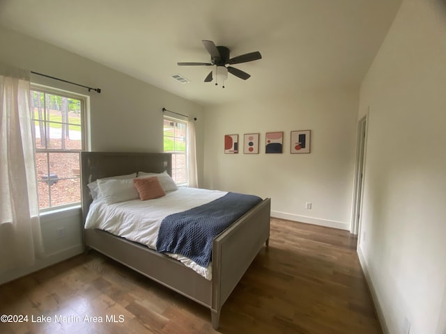 bedroom with ceiling fan and dark wood-type flooring