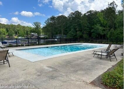 130 Martin Ridge Trce, Tallassee, AL 36078 - view of swimming pool with a patio area and a forest view