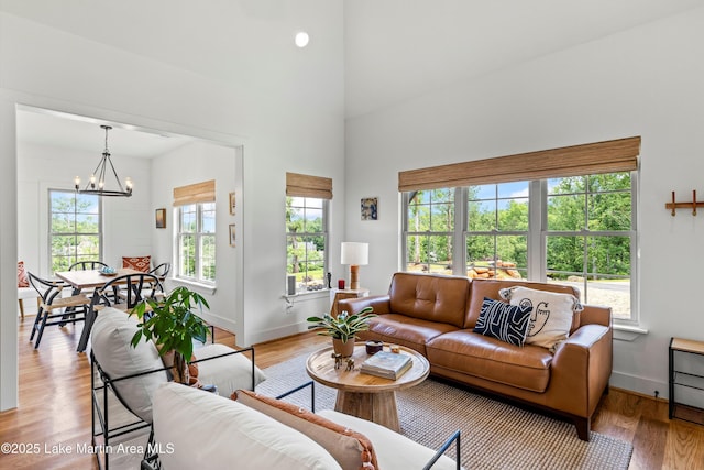 224 Village Trl, Dadeville, AL 36853 - living area featuring a chandelier, light wood-style floors, baseboards, and a high ceiling