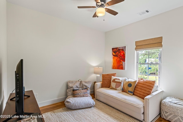 224 Village Trl, Dadeville, AL 36853 - living room with wood finished floors, a ceiling fan, and baseboards
