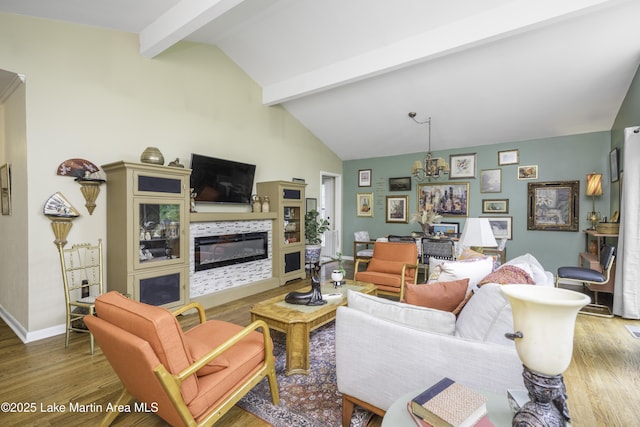 1751 Clubview Dr, Alexander City, AL 35010 - living room with wood finished floors, a glass covered fireplace, and a chandelier