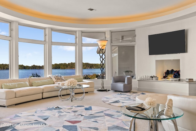 1020 Wake Robin, Eclectic, AL 36024 - carpeted living room with visible vents, a water view, and a wealth of natural light