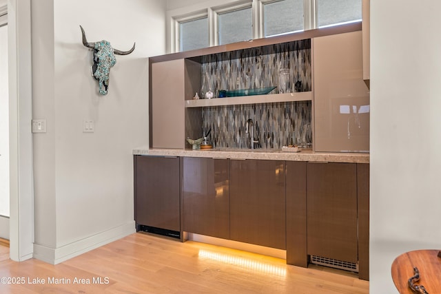 1020 Wake Robin, Eclectic, AL 36024 - bar featuring a sink, baseboards, indoor bar, and light wood-style flooring