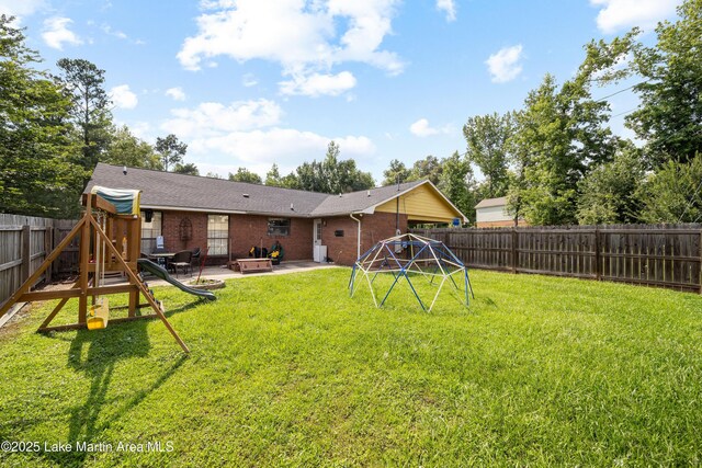 1258 Watson St, Alexander City, AL 35010 - rear view of property with a playground, a patio area, brick siding, and a fenced backyard