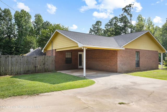 1258 Watson St, Alexander City, AL 35010 - view of side of home with an attached carport, brick siding, concrete driveway, and roof with shingles