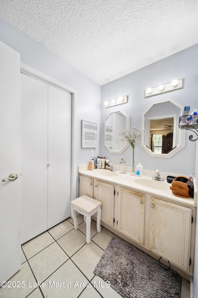 1258 Watson St, Alexander City, AL 35010 - full bathroom featuring tile patterned flooring, double vanity, and a textured ceiling