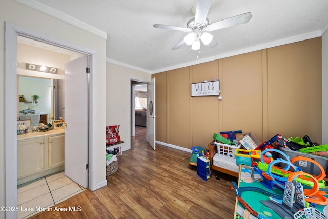 1258 Watson St, Alexander City, AL 35010 - rec room with a ceiling fan, crown molding, light wood-style floors, and a textured ceiling
