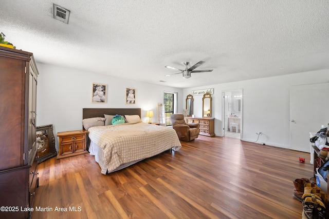 1258 Watson St, Alexander City, AL 35010 - bedroom with a textured ceiling, wood finished floors, connected bathroom, and ceiling fan