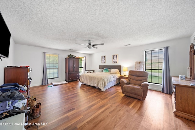 1258 Watson St, Alexander City, AL 35010 - bedroom with wood finished floors, a textured ceiling, and ceiling fan