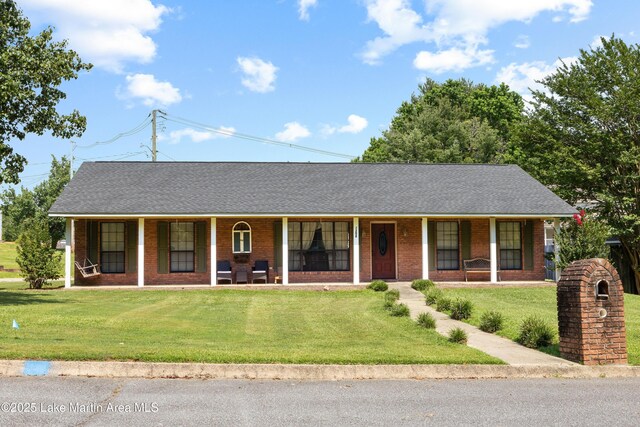 1258 Watson St, Alexander City, AL 35010 - ranch-style home featuring a porch, brick siding, a front lawn, and roof with shingles