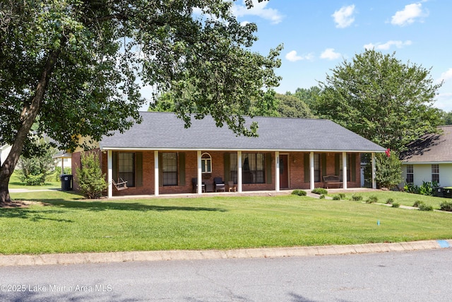 1258 Watson St, Alexander City, AL 35010 - ranch-style house with covered porch, a front lawn, brick siding, and a shingled roof