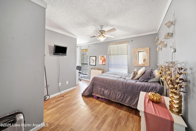 1258 Watson St, Alexander City, AL 35010 - bedroom with crown molding, light wood-type flooring, a textured ceiling, and a ceiling fan