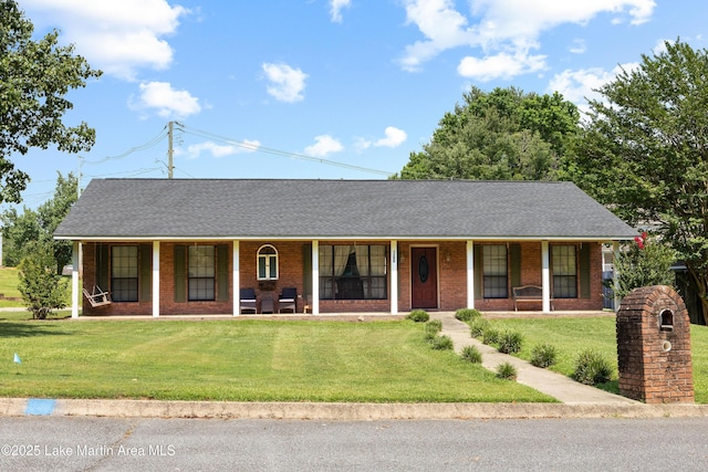 1258 Watson St, Alexander City, AL 35010 - ranch-style home featuring a porch, brick siding, a front lawn, and roof with shingles