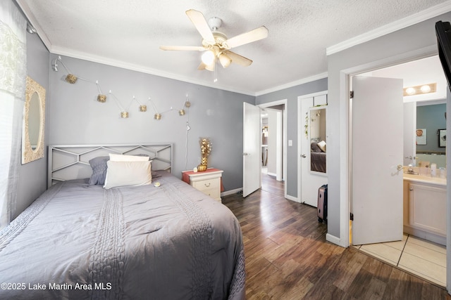 1258 Watson St, Alexander City, AL 35010 - bedroom with wood finished floors, crown molding, a ceiling fan, ensuite bathroom, and a textured ceiling