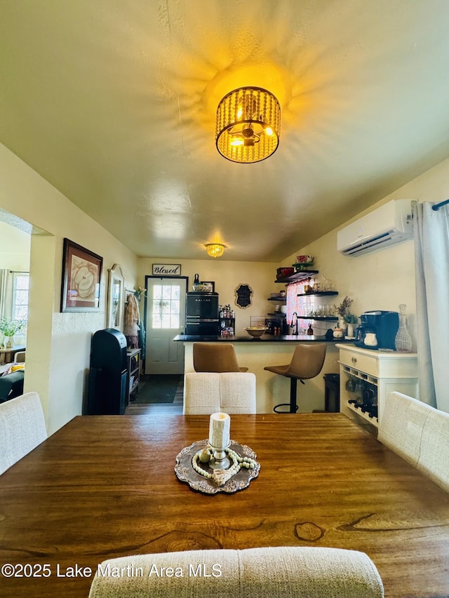 dining room featuring a wall mounted AC and sink