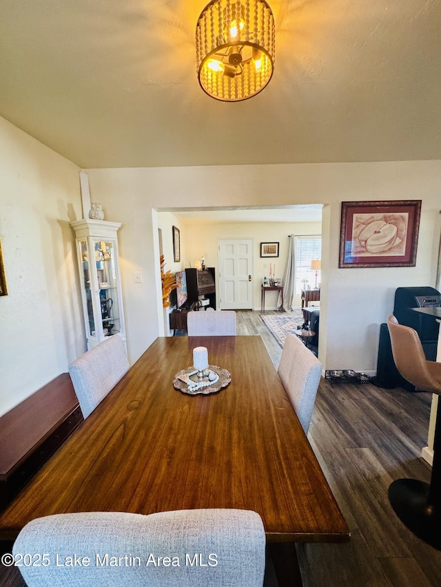 dining space with wood-type flooring