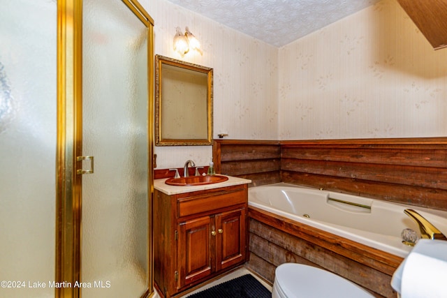 full bathroom featuring vanity, shower with separate bathtub, a textured ceiling, and toilet