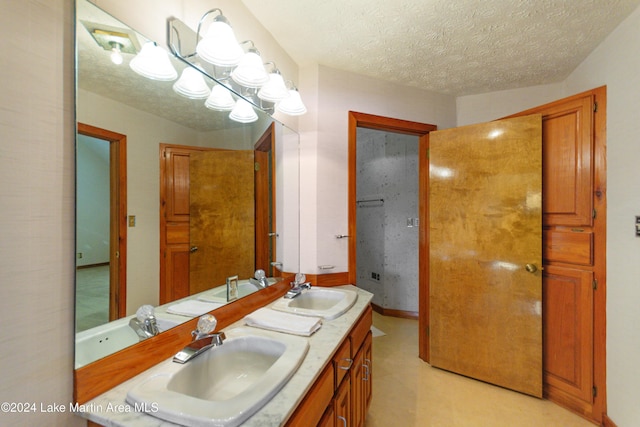 bathroom with vanity and a textured ceiling