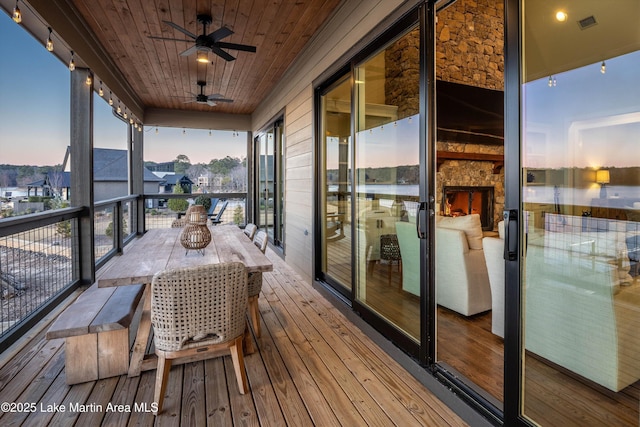 2082 River Oaks Dr, Jacksons Gap, AL 36861 - deck at dusk featuring ceiling fan and outdoor dining space
