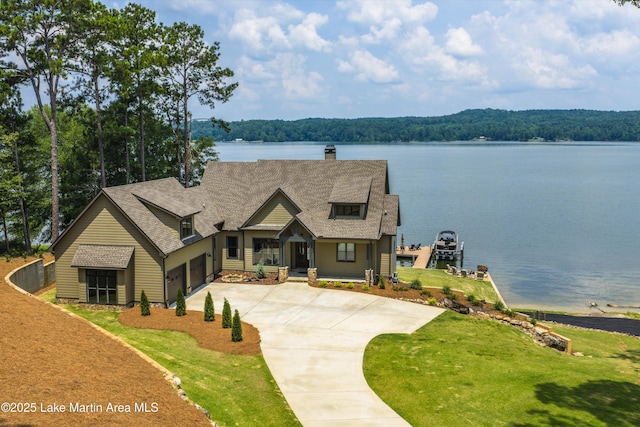 2082 River Oaks Dr, Jacksons Gap, AL 36861 - view of front of home featuring a chimney, a water view, driveway, a front yard, and a view of trees