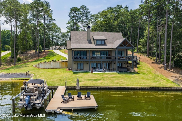 2082 River Oaks Dr, Jacksons Gap, AL 36861 - rear view of house with a patio area, a deck with water view, a yard, and a chimney