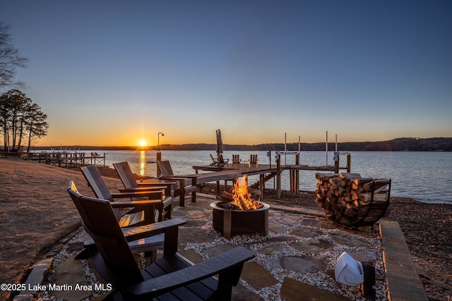 2082 River Oaks Dr, Jacksons Gap, AL 36861 - patio terrace at dusk with a fire pit, a water view, and a dock