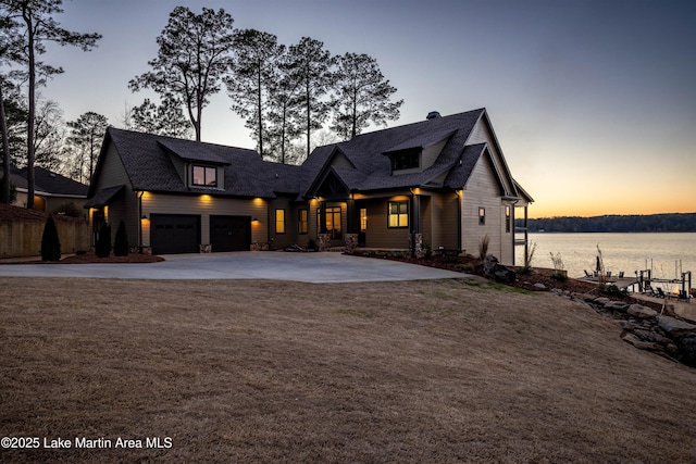 2082 River Oaks Dr, Jacksons Gap, AL 36861 - view of front facade with driveway, a water view, and roof with shingles