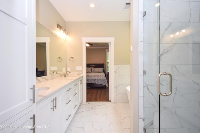 120 Rocky Creek Dr, Alexander City, AL 35010 - ensuite bathroom featuring double vanity, marble finish floors, a freestanding bath, a marble finish shower, and recessed lighting