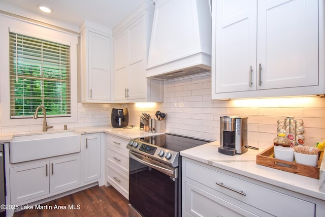 120 Rocky Creek Dr, Alexander City, AL 35010 - kitchen featuring stainless steel electric range oven, custom range hood, white cabinets, decorative backsplash, and light stone countertops