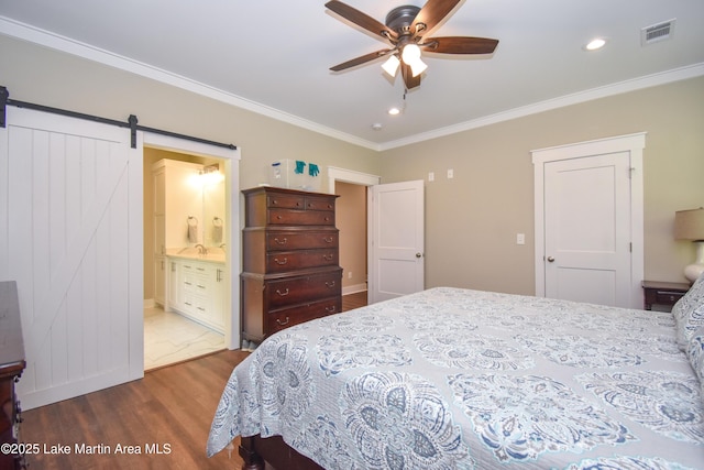 120 Rocky Creek Dr, Alexander City, AL 35010 - bedroom featuring wood finished floors, a barn door, crown molding, connected bathroom, and recessed lighting