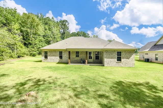 120 Rocky Creek Dr, Alexander City, AL 35010 - rear view of house with a patio area, brick siding, and a yard
