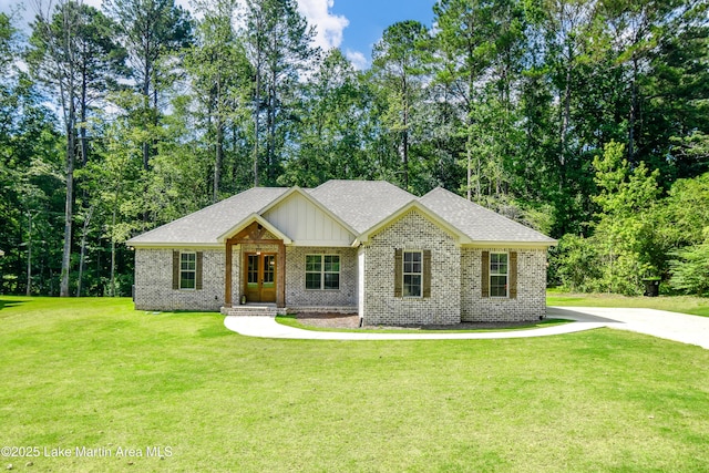 120 Rocky Creek Dr, Alexander City, AL 35010 - view of front of property with brick siding, board and batten siding, a front lawn, and roof with shingles