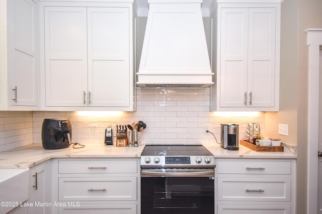 120 Rocky Creek Dr, Alexander City, AL 35010 - kitchen with stainless steel electric range, custom range hood, white cabinetry, decorative backsplash, and light stone countertops