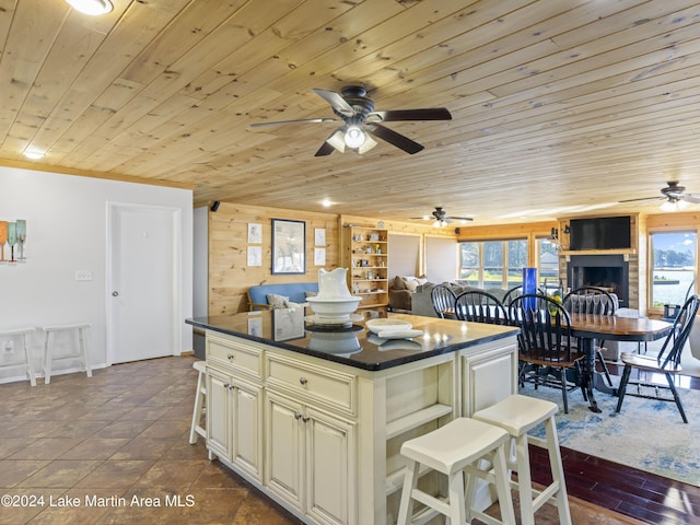 kitchen with a healthy amount of sunlight, a center island, cream cabinets, and wooden ceiling