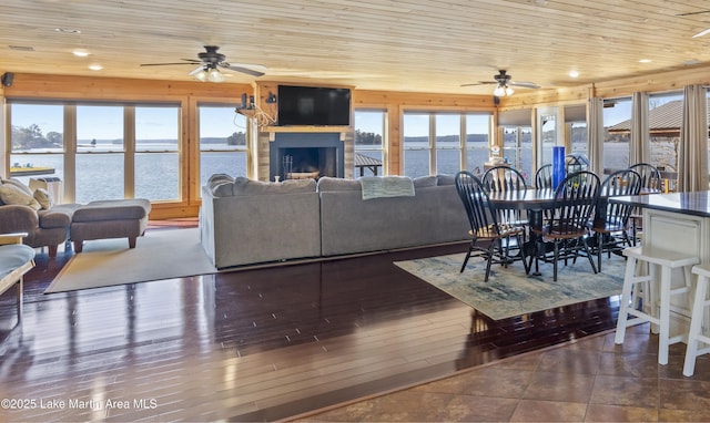 living room with hardwood / wood-style flooring, ceiling fan, plenty of natural light, and wooden ceiling