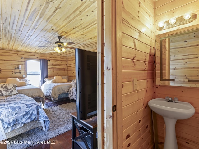 bathroom with hardwood / wood-style floors, wood ceiling, wooden walls, and ceiling fan