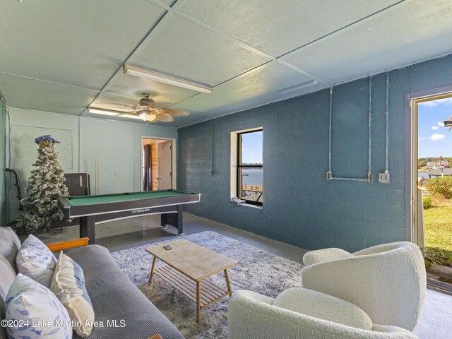 game room with pool table, concrete flooring, and a wealth of natural light