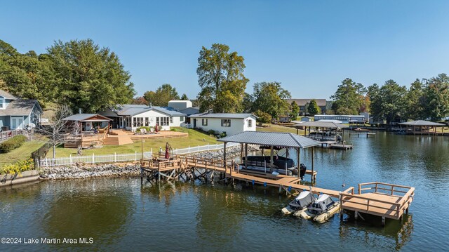 view of dock featuring a water view and a yard