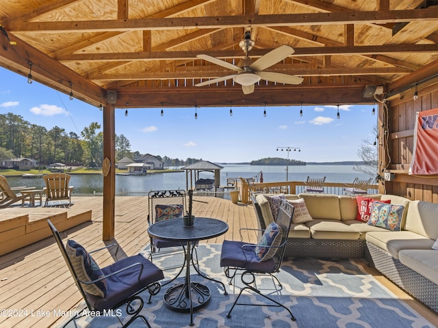 deck featuring a gazebo, a water view, outdoor lounge area, and ceiling fan