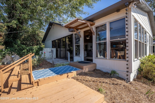 rear view of property featuring a deck