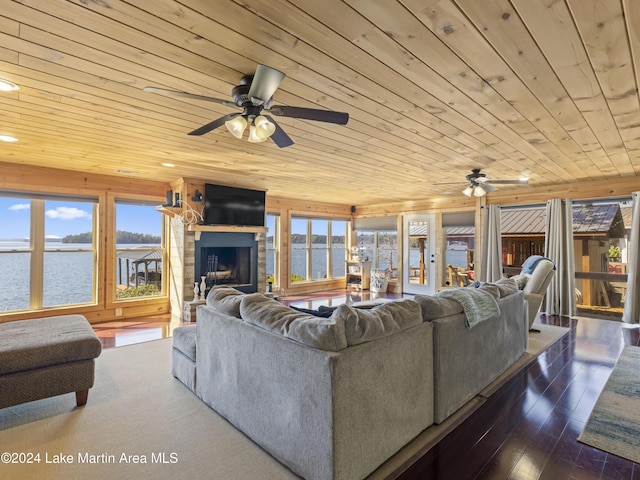 living room with ceiling fan, dark wood-type flooring, and wood ceiling