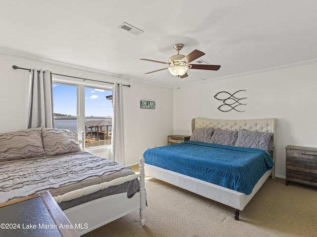 carpeted bedroom with ceiling fan and ornamental molding