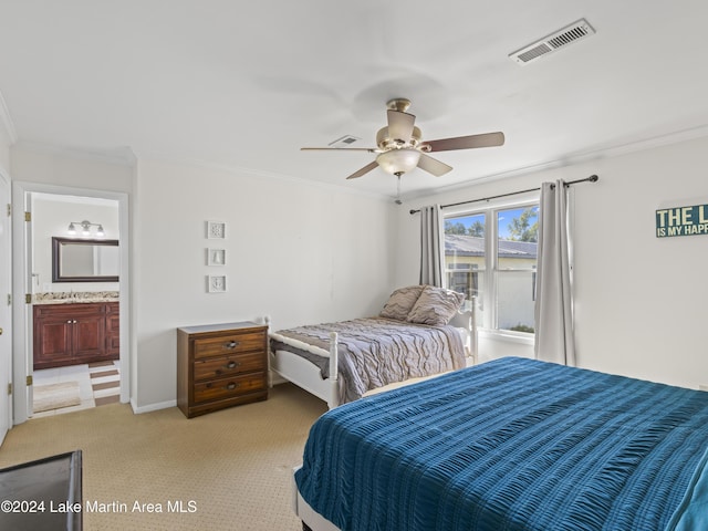 bedroom featuring crown molding, light colored carpet, ceiling fan, and ensuite bathroom